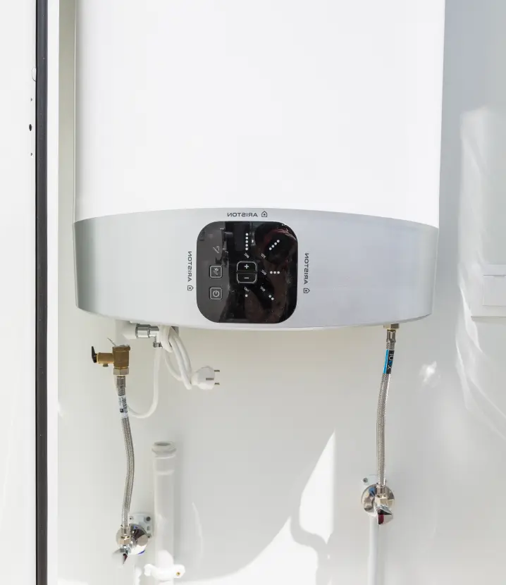 Modern white boiler with a small display for setting the water temperature 